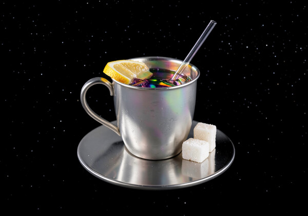 Flux 2 Klein example: iridescent drink in a metal mug against a starry black background