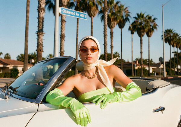 Flux 2 Klein example: woman in lime green gloves and headscarf in a white vintage convertible