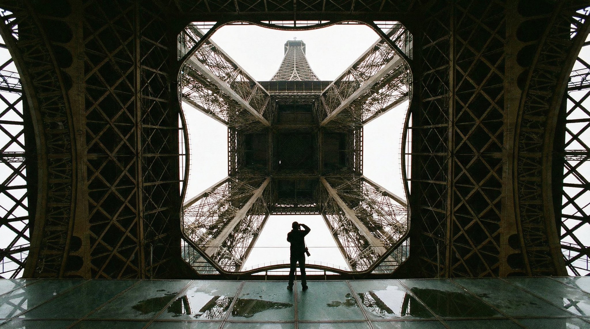Nano Banana 2 example: symmetrical upward view through Eiffel Tower ironwork to the sky