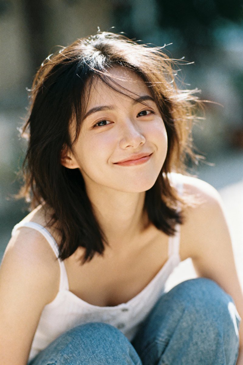 Seedream 4 example: young woman smiling in a white tank top with soft outdoor bokeh