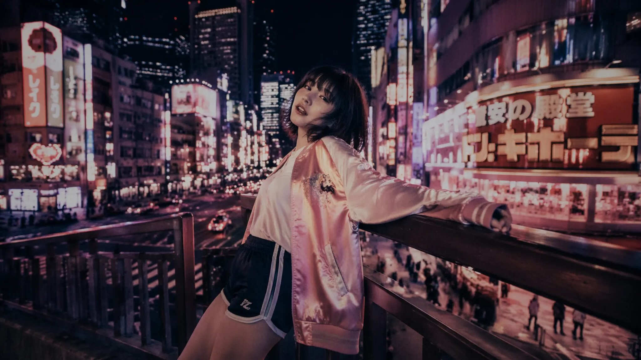 Seedream 5 Pro example: woman in a pink satin jacket on a neon-lit Tokyo street at night